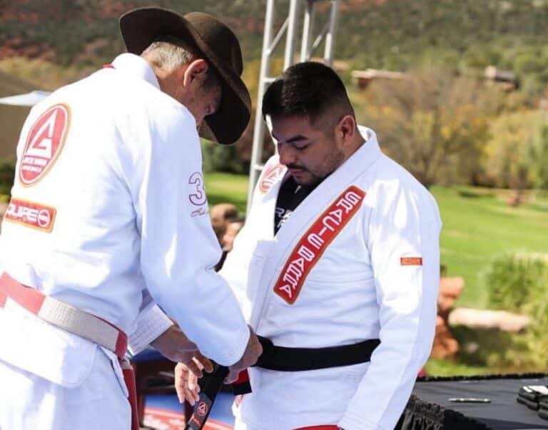 Arizona Fighter Foundation Instructor Tying belt onto student